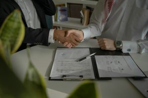 Business professionals reviewing agreement documents