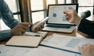 Two business partnership coworkers analysis strategy with discussing a financial planning graph and company budget during a budget meeting in office room. photo – Office Image on Unsplash